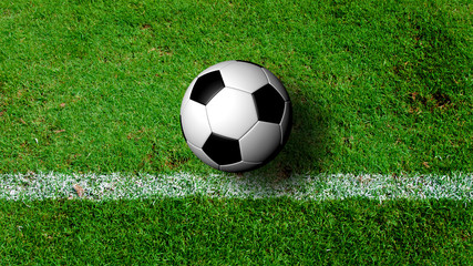Fototapeta premium Soccer Ball on green grass field from top view