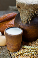 Composition of milk on the bread, the old background
