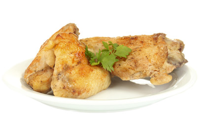 roasted chicken wings and leg with parsley in the plate