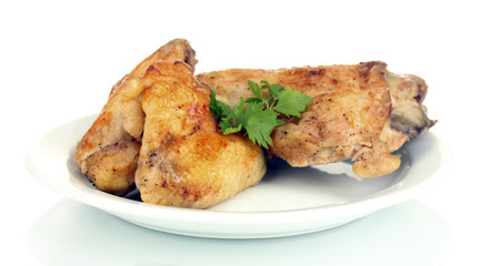 roasted chicken wings and leg with parsley in the plate