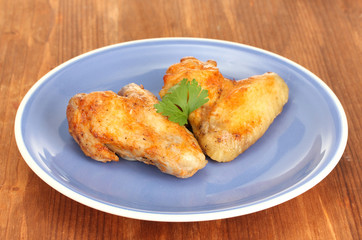 roasted chicken leg with parsley in the plate