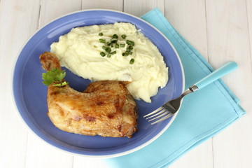 roasted chicken leg with mashed potato in the plate