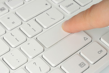 Finger pushing the button of keyboard