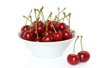Fototapeta na wymiar Bowl of sweet cherries on white background