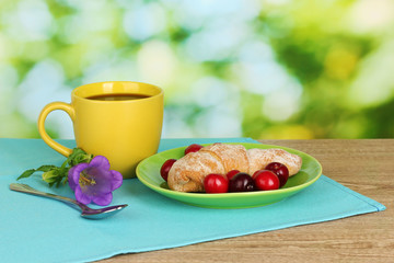 Croissant with cherries and coffee