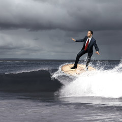 Young business person surfing on the waves