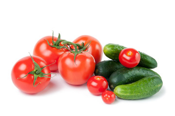 Close-up of ripe tomatoes and cucumbers, white background