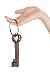 woman's hand holding a bunch of antique keys on white
