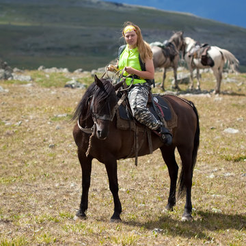 tourist with backpack on horseback