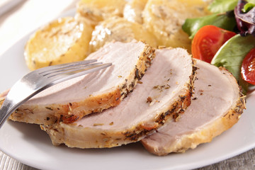 slice of roast pork and vegetables