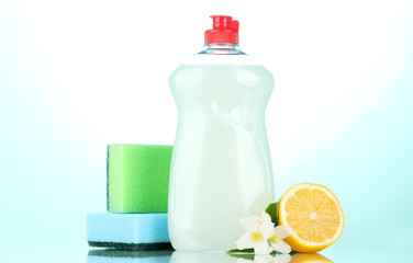 Dishwashing liquid with sponges and lemon with flowers