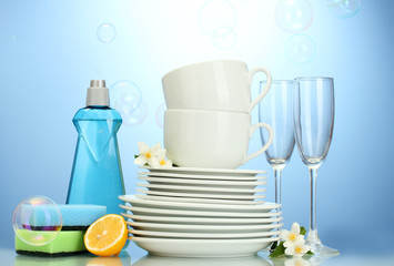 empty clean plates, glasses and cups with dishwashing liquid