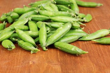Green peas on wooden background
