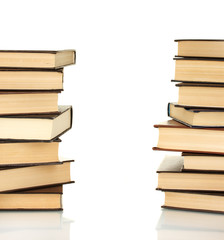 Two towers of books on white background close-up