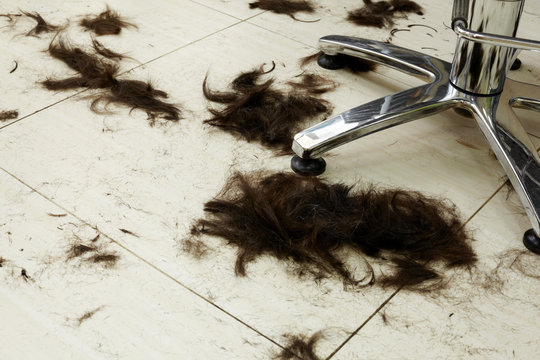 Cut Hair On The Floor In A Hairdressing Salon.