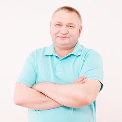 Pleased senior man in polo over white
