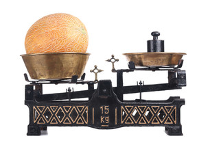 Old-fashioned balance scale with melon
