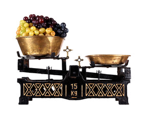 Old-fashioned balance scale with grapes