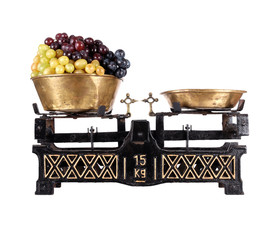Old-fashioned balance scale with grapes