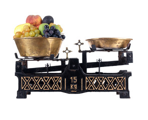 Old-fashioned balance scale with fruits