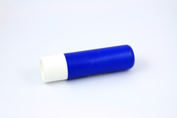 Blue tube of lip balm isolated on white background