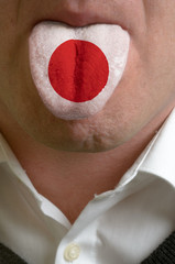 man tongue painted in japan flag symbolizing to knowledge to spe