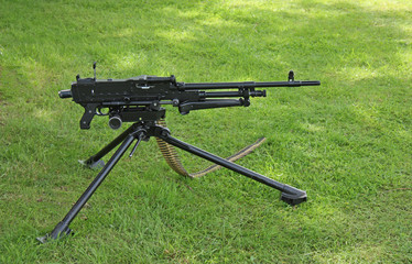 A Modern Military Machine Gun Set Up On Grass.