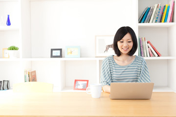 a young asian woman using laptop computer