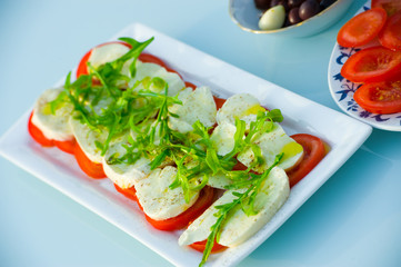 mozzarella with tomato and arugula