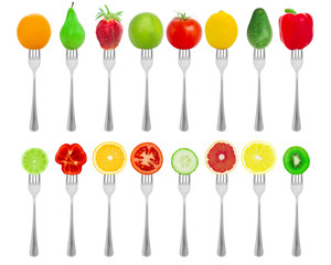 Fruit and vegetables on forks isolated on a white background