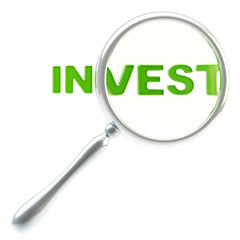 Word "invest" under the magnifier isolated