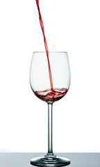Start to pour red wine into wine glass