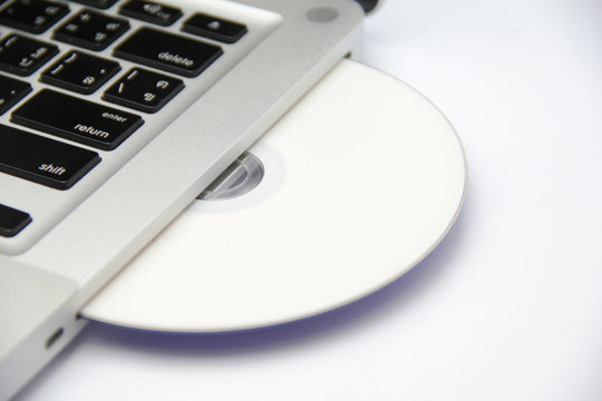 white cd or dvd disk in laptop