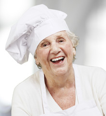 portrait of a senior woman cook smiling, indoor