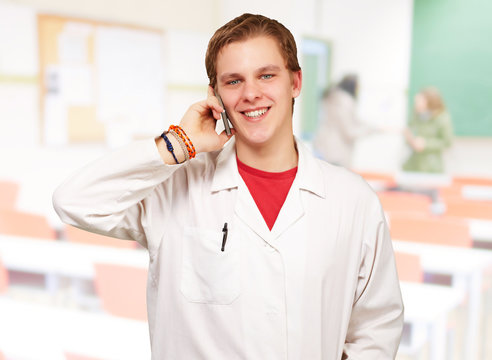 portrait of young academic talking on mobile at classroom