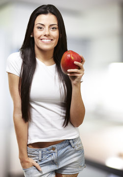 woman holding a mango