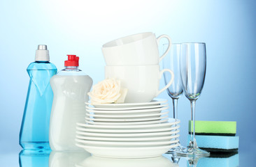 empty clean plates, glasses and cups with dishwashing liquid