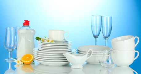 empty clean plates, glasses and cups with dishwashing liquid