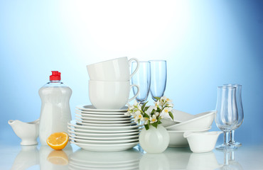 empty clean plates, glasses and cups with dishwashing liquid