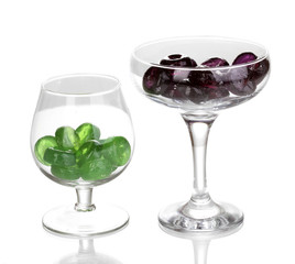 Color candies in glasses isolated on white