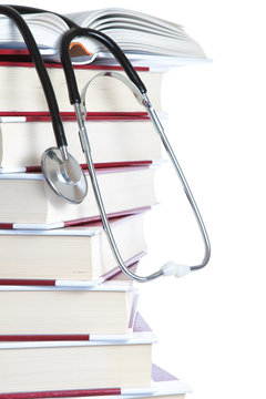 Stack Of Books And A Stethoscope Medical On A White Background.