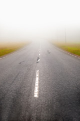 Naklejka premium asphalt road in fog
