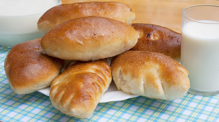 Appetizing baked house pies with fresh milk
