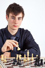 Young business man playing chess