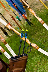 Archery equipment shot at an angle. Bows, arrows, and quiver.