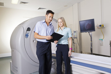 Naklejka na ściany i meble Doctor and nurse with MRI scanner
