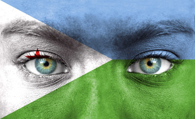 Human face painted with flag of Djibouti