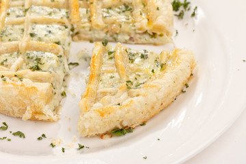 tasty quiche with cheese and herbs