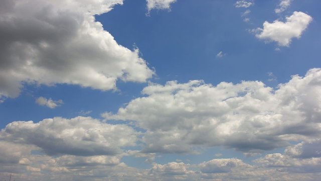 Clouds over blue sky. Time lapse