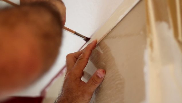 Painter - painting door frame red - precise with guide rail
